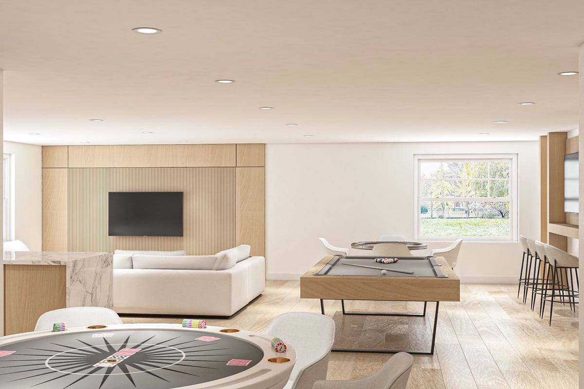 A contemporary interior featuring a stylish entertainment room with poker and pool tables, elegant furnishings, and wooden decor